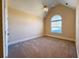 Cozy bedroom with carpet flooring, vaulted ceiling, and a bright arched window at 8008 Revere Dr, Mcdonough, GA 30252