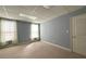 Bedroom with gray walls, carpet, and double-hung windows at 8008 Revere Dr, Mcdonough, GA 30252