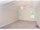 Spacious bedroom with a tray ceiling, ceiling fan, and neutral carpet at 8008 Revere Dr, Mcdonough, GA 30252