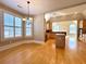 Well-lit dining area adjacent to a modern kitchen with hardwood flooring and large windows at 8008 Revere Dr, Mcdonough, GA 30252