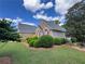 Beautifully landscaped home exterior with brick and siding at 8008 Revere Dr, Mcdonough, GA 30252