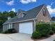 Charming home exterior with a two-car garage and well-manicured landscaping at 8008 Revere Dr, Mcdonough, GA 30252