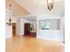 Bright, open living area with hardwood floors, chandeliers, and detailed ceiling trim at 8008 Revere Dr, Mcdonough, GA 30252