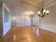 Bright living room with hardwood floors, tray ceiling, wainscoting, and a view of the front door at 8008 Revere Dr, Mcdonough, GA 30252
