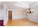 Spacious living room featuring detailed molding, hardwood floors, and a stylish chandelier at 8008 Revere Dr, Mcdonough, GA 30252