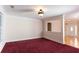 Cozy carpeted room with large windows, decorative trim, and an open layout to the entry hall at 8008 Revere Dr, Mcdonough, GA 30252