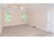 Large main bedroom features tray ceilings, neutral walls, and large windows for natural light at 8008 Revere Dr, Mcdonough, GA 30252