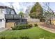 Landscaped backyard features a stone retaining wall and grassy area at 1100 Virginia Ne Ave, Atlanta, GA 30306