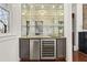Stylish bar area featuring a mirrored backsplash, granite countertop, and built-in beverage refrigerators at 1100 Virginia Ne Ave, Atlanta, GA 30306