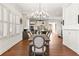 Elegant dining room featuring a modern chandelier, hardwood floors, and views into the kitchen area at 1100 Virginia Ne Ave, Atlanta, GA 30306