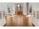 Open foyer featuring hardwood floors, white columns, and natural light streaming through the glass front door at 1100 Virginia Ne Ave, Atlanta, GA 30306