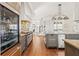 Modern kitchen features stainless steel appliances, an island with seating, hardwood floors, and custom cabinetry at 1100 Virginia Ne Ave, Atlanta, GA 30306