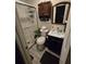 Compact bathroom featuring a glass shower, modern sink and cabinet combo at 2077 Brockett Rd, Tucker, GA 30084