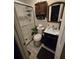 Compact bathroom with a glass-enclosed shower, vanity, and toilet, designed for functionality and style at 2077 Brockett Rd, Tucker, GA 30084