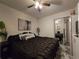 Comfortable bedroom featuring a mirrored closet, neutral walls, and ceiling fan at 2077 Brockett Rd, Tucker, GA 30084