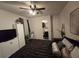 Bedroom featuring a ceiling fan, neutral walls, art and closet with mirror at 2077 Brockett Rd, Tucker, GA 30084