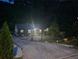 Night view of charming single-story home with well-maintained landscaping and long driveway with ample parking at 2077 Brockett Rd, Tucker, GA 30084