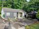 Charming single-story home with gray siding, a carport with basketball hoop, and mature trees in the front yard at 2077 Brockett Rd, Tucker, GA 30084