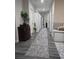 Hallway with wood floors, soft rug, plants and an entrance to the bathroom at 2077 Brockett Rd, Tucker, GA 30084