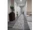 Long hallway with a rug and doors and a decor plant and antique cabinet at 2077 Brockett Rd, Tucker, GA 30084