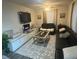 Comfortable living room featuring an area rug and modern decor at 2077 Brockett Rd, Tucker, GA 30084