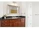 Bathroom featuring a vanity with a dark countertop, framed mirror, decorative plant, and a view into the shower at 325 E Paces Ferry Ne Rd # 907, Atlanta, GA 30305