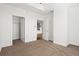 Spacious empty bedroom with neutral carpet, white trim, and two open doors leading to a closet and hallway at 325 E Paces Ferry Ne Rd # 907, Atlanta, GA 30305