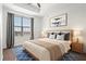 Bright bedroom with tray ceiling, large window and blue rug features a well-made bed and calming neutral decor at 325 E Paces Ferry Ne Rd # 907, Atlanta, GA 30305