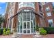 Classic brick building with ornate glass entrance and manicured landscaping at 325 E Paces Ferry Ne Rd # 907, Atlanta, GA 30305