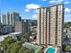 Exterior view showcasing the high-rise building, pool, and tennis court amenities at 325 E Paces Ferry Ne Rd # 907, Atlanta, GA 30305
