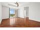 Spacious living room with hardwood floors, a ceiling fan, and balcony access with city views at 325 E Paces Ferry Ne Rd # 907, Atlanta, GA 30305
