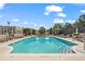 Rooftop pool with chaise lounges, umbrellas, tables, and chairs, surrounded by lush landscaping and a city view at 325 E Paces Ferry Ne Rd # 907, Atlanta, GA 30305