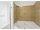 Shower and soaking tub features a tiled enclosure, a shower head, and neutral decor at 325 E Paces Ferry Ne Rd # 907, Atlanta, GA 30305