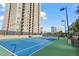 Tennis court with an apartment building in the background, offering a fun recreational activity at 325 E Paces Ferry Ne Rd # 907, Atlanta, GA 30305