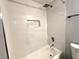 Stylish white marbled tile shower with shower head and recessed shelf at 1502 Huntingdon Chase, Atlanta, GA 30350