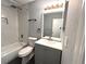 A modern bathroom featuring a shower-over-bath, gray vanity and black accessories at 1502 Huntingdon Chase, Atlanta, GA 30350