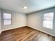 Bedroom with hardwood floors, neutral paint, and ample natural light at 1502 Huntingdon Chase, Atlanta, GA 30350