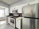 Updated kitchen with stainless steel appliances, granite countertops, and modern white cabinets at 1502 Huntingdon Chase, Atlanta, GA 30350