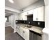 Well-lit kitchen showcasing white cabinets, black backsplash and stainless steel dishwasher at 1502 Huntingdon Chase, Atlanta, GA 30350