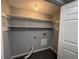 A practical laundry room with spacious white shelving and gray walls at 1502 Huntingdon Chase, Atlanta, GA 30350