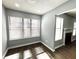 Brightly lit room featuring wood flooring, a large window, and a fireplace at 1502 Huntingdon Chase, Atlanta, GA 30350