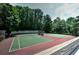 Two tennis courts surrounded by lush green trees and foliage at 1502 Huntingdon Chase, Atlanta, GA 30350