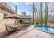 Inviting backyard with wooden deck, above ground pool, outdoor bar, and table with seating at 3175 Pond Ridge Trl, Snellville, GA 30078