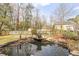 Beautiful backyard pond with rock accents and mature trees at 3175 Pond Ridge Trl, Snellville, GA 30078