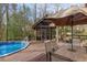 Relaxing backyard includes an in-ground pool, a deck with seating, and a screened-in porch at 3175 Pond Ridge Trl, Snellville, GA 30078