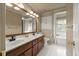Bathroom with double sinks, a large mirror, storage and a separate tub at 3175 Pond Ridge Trl, Snellville, GA 30078