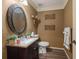 Stylish powder room featuring a decorative mirror, elegant accents and neutral tones at 3175 Pond Ridge Trl, Snellville, GA 30078
