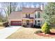 Charming two-story home featuring a well-manicured lawn, attached two car garage and inviting front porch at 3175 Pond Ridge Trl, Snellville, GA 30078