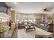 Bright living room showcasing a stone fireplace, large windows, and cozy furnishings at 3175 Pond Ridge Trl, Snellville, GA 30078