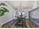 Bright dining room featuring modern chandelier, neutral walls and wood-look flooring and access to back deck at 4853 Chapelle Ct, Marietta, GA 30066